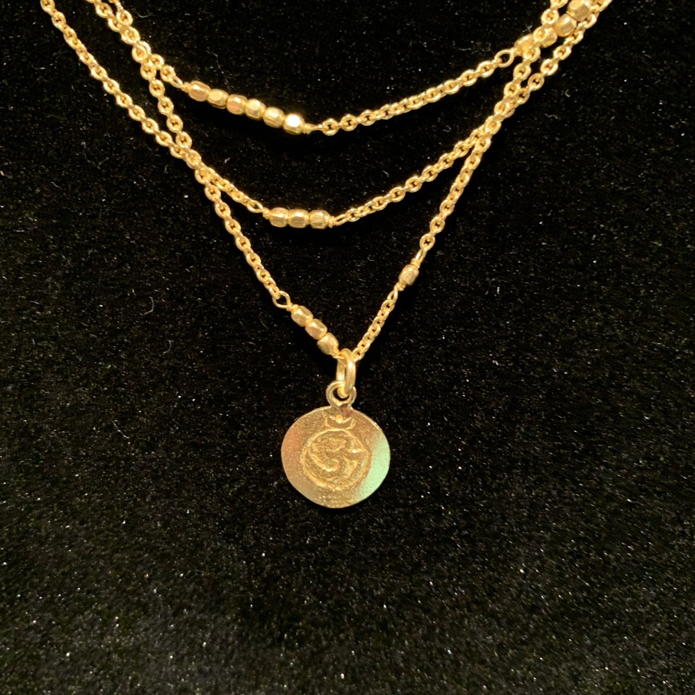 Gold triple string necklace with small medallion